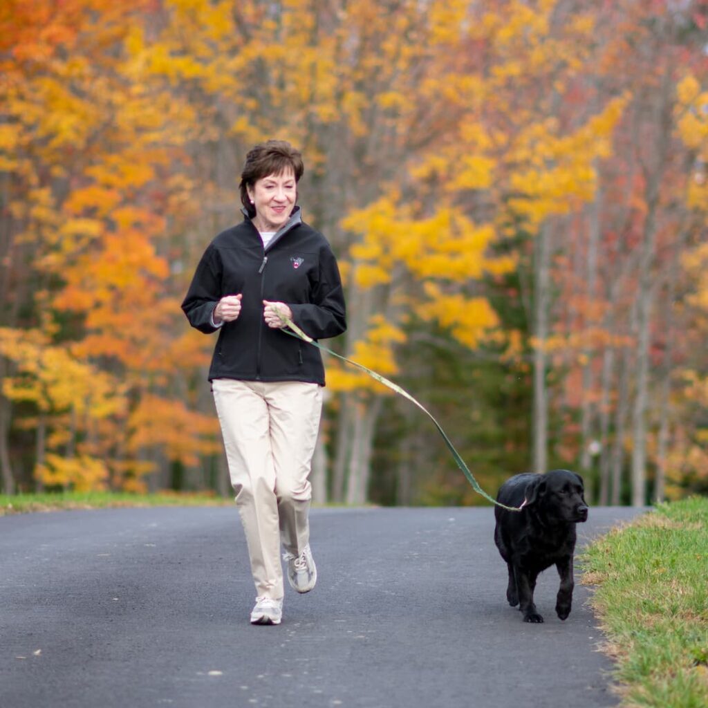 Susan Collins running with her dog, Pepper.